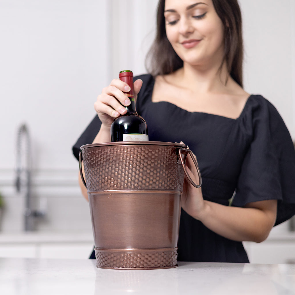 Wine bucket to hold wine or champagne.  Made of premium galvanized metal with an elegant hammered exterior and glossy finish.  Extra durable and sealed to prevent leaking.  Holds 1 or 2 bottles of wine.