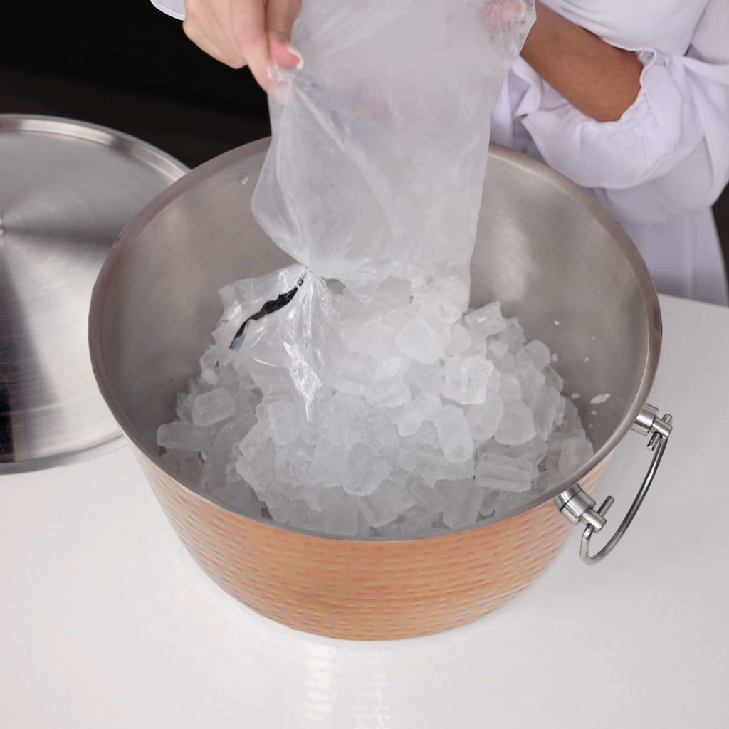 Insulated ice bucket with lid for parties.  This double walled beverage tub includes a lid making it perfect to keep  up to 3 gallons of ice for cocktails.  Elegant rose copper hammered exterior and two handles for easy transport from room to room.