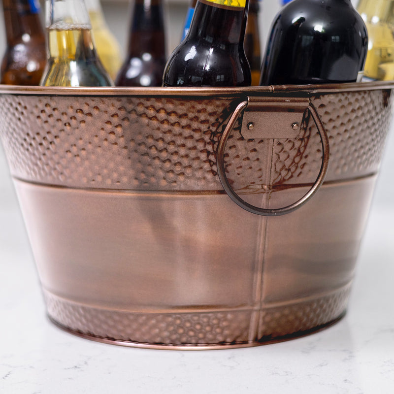 Metal ice bucket with strong swing handles to hold ice and drinks when serving at a party.