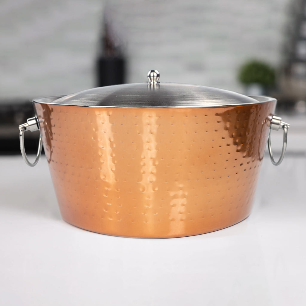Insulated ice bucket with lid for parties.  This double walled beverage tub includes a lid making it perfect to keep  up to 3 gallons of ice for cocktails.  Elegant rose copper hammered exterior and two handles for easy transport from room to room.