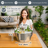 Woman holding a large metal bucket with drinks and ice.  There are measurement details 18" diameter x 9" height & 6.25 gallon size.