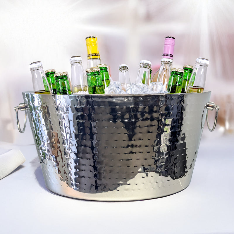 Stainless steel ice bucket that is very reflective and includes a hammered exterior.  The bucket includes to handles with bottles chilled by ice inside.
