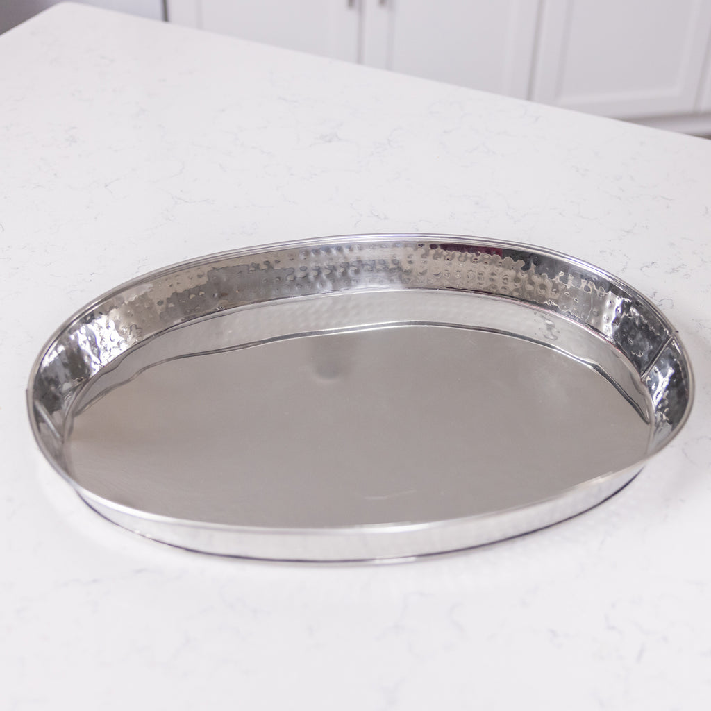Serving tray made of stainless steel with a hammered exterior and easy to clean high glossy finish.  For wedding, birthday, or holiday party use in your home or on your patio.