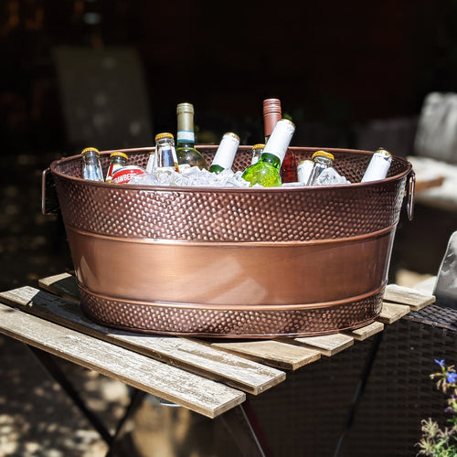 Large oval metal drink tub for chilling drinks with ice for parties out on the patio.  Sealed to be leak resistant with glossy easy to clean finish.